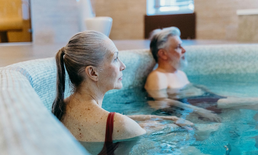 senior man and woman relaxing in hot tub - are hot tubs good for arthritis?